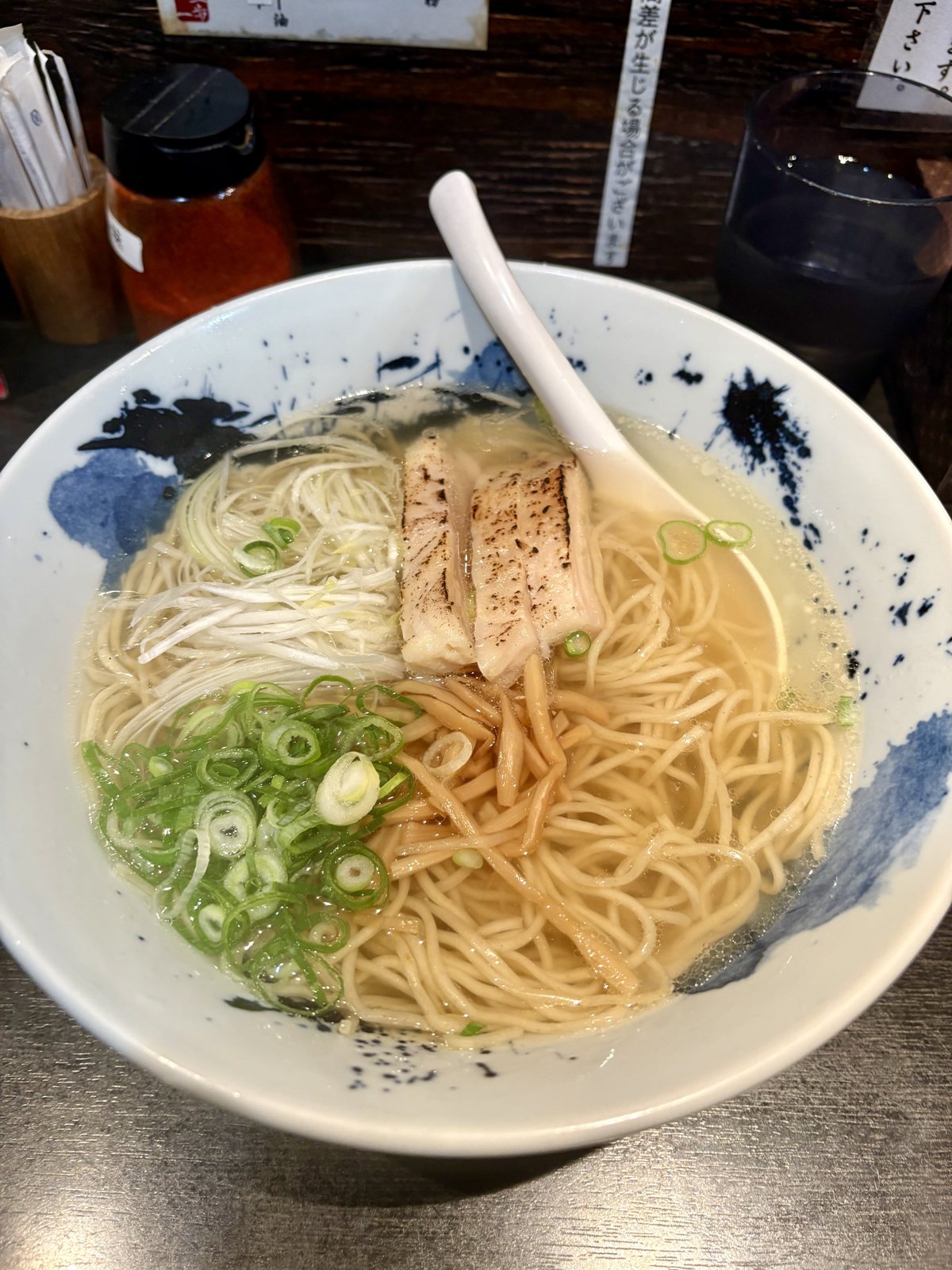 A clear shio ramen with charred pork and spring onion
