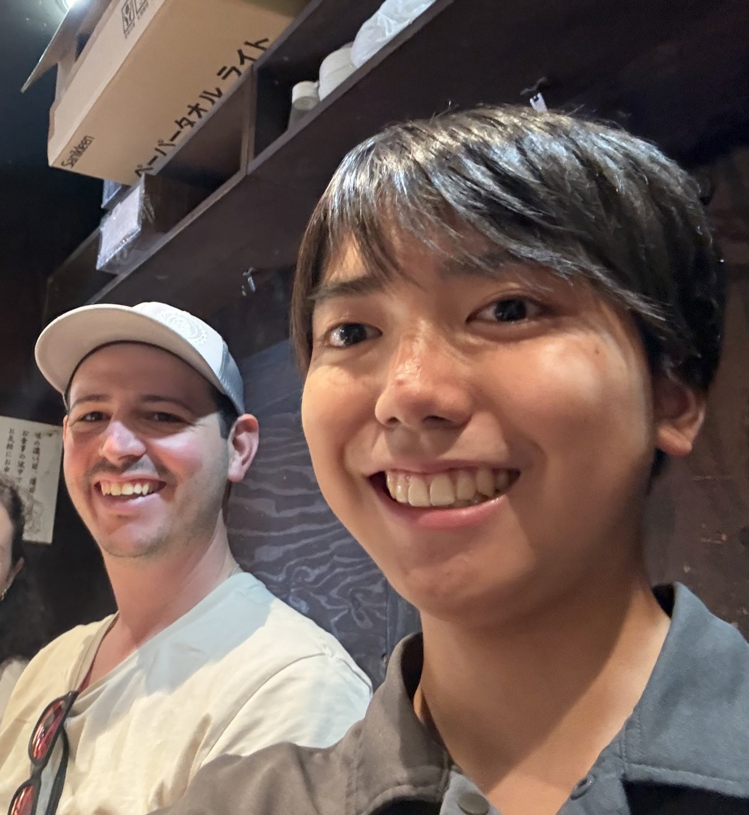 Hiro and a guest smiling at a ramen counter